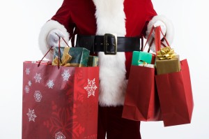 Santa Carrying Shopping Bags --- Image by © Royalty-Free/Corbis